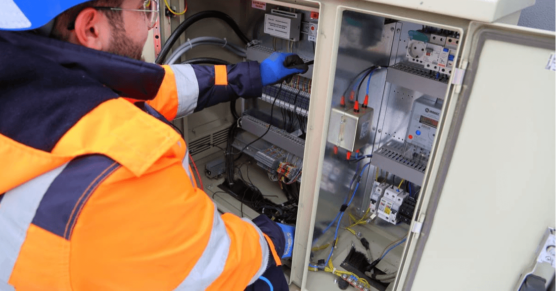 Electrical engineer working on a building services panel on site