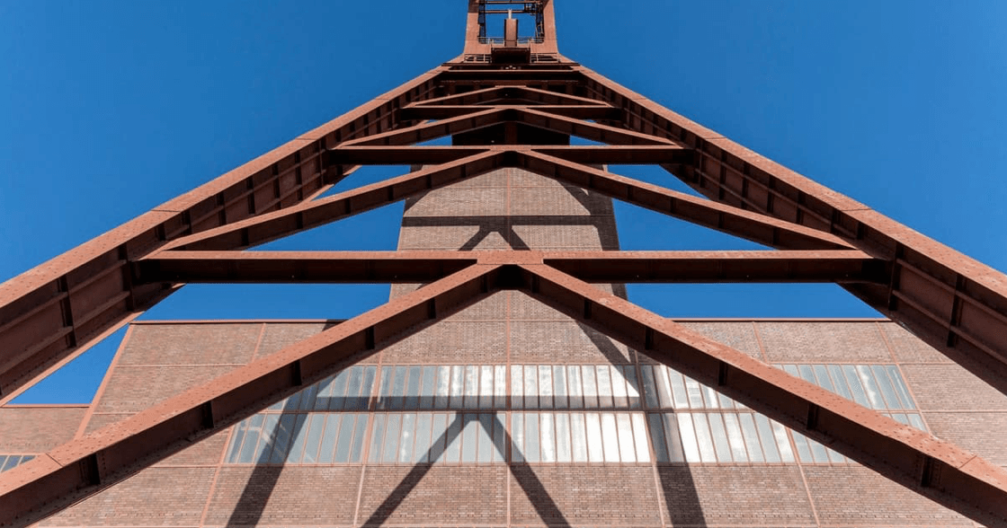 Steel structural framework under construction against a clear sky
